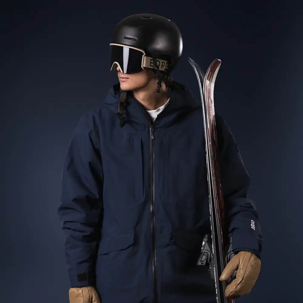 Man wearing blue ski clothes and goggles