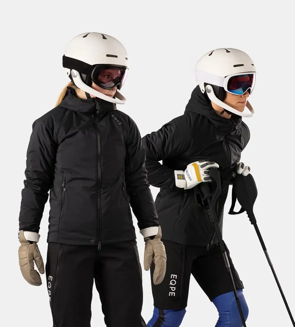 Skiers wearing black alpine race gear