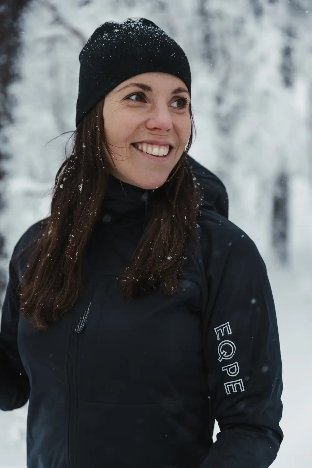 Woman in black training clothes outside during winter