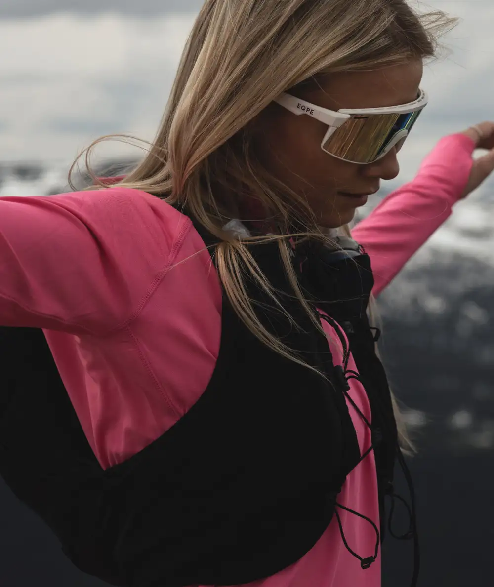 A woman in athletic gear and sport eyewear.
